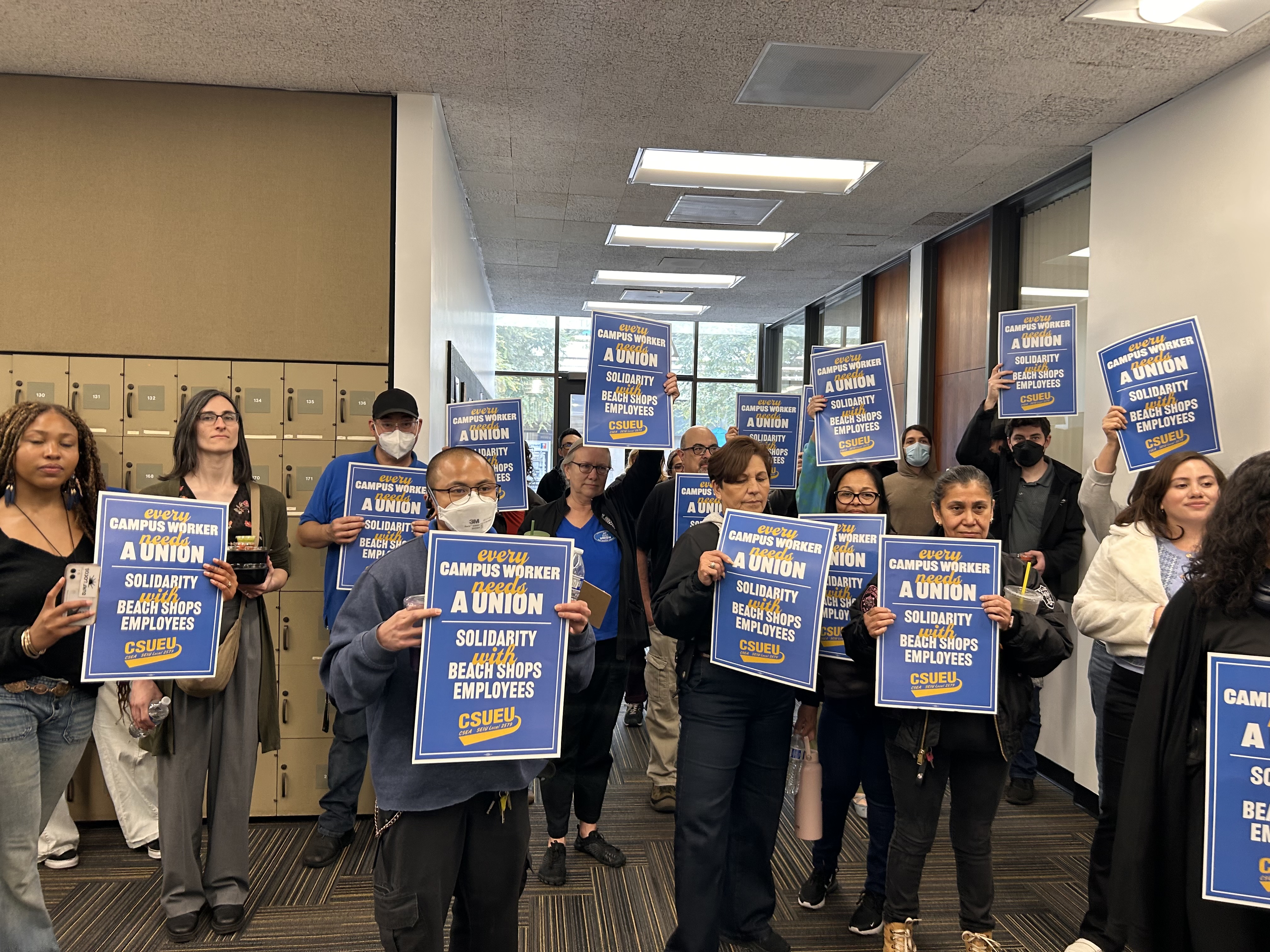 Campus workers standing in solidarity with Beach Shops employees